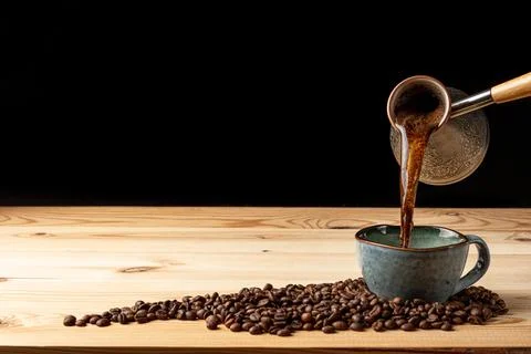 Handmade cup with coffee on the table Stock Photos