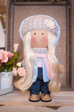 Handmade doll in the interior. Stock Photos