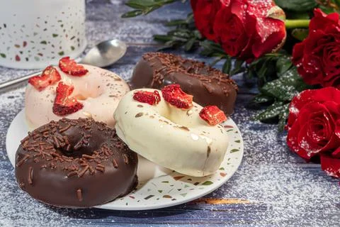 Handmade donuts on a light background in white and black chocolate. There are Фото