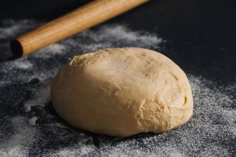 Handmade dough for bread on dark table background Stock Photos