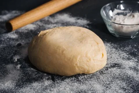 Handmade dough for bread on dark table background Stock Photos