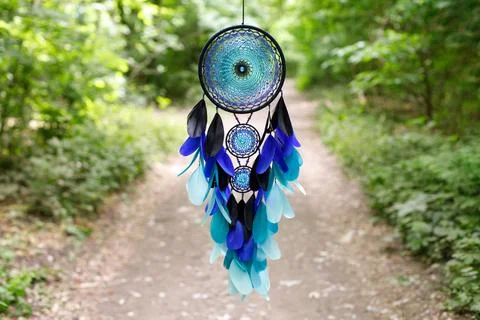 Handmade dream catcher with feathers threads and beads rope hanging Stock-Fotos