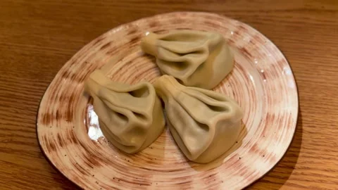Handmade Dumplings On Wooden Table, Five Pleated Khinkali Arranged On Ceramic Stock Footage 325232833