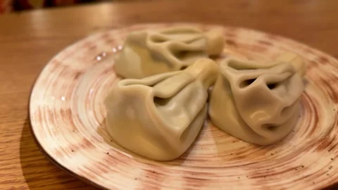 Handmade Dumplings On Wooden Table, Five Pleated Khinkali Arranged On Ceramic Stock Footage 325232882