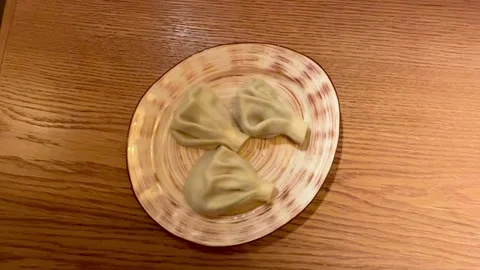 Handmade Dumplings On Wooden Table, Five Pleated Khinkali Arranged On Ceramic Stock Footage 325233902