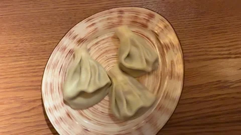 Handmade Dumplings On Wooden Table, Five Pleated Khinkali Arranged On Ceramic Stock Footage 325233987