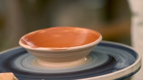 Handmade earthenware bowl with red interior glaze Stock Footage 115083573