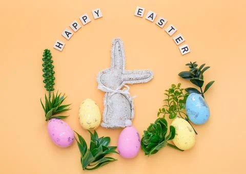 Handmade Easter decor, stylish Easter eggs, textile rabbit willow branches an Stock Photos