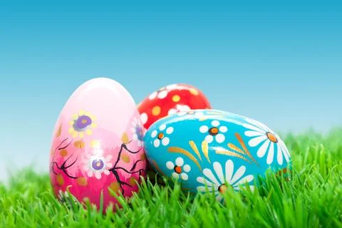 Handmade Easter eggs on grass. Spring patterns, unique. Stock Photos
