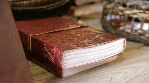 Handmade Embossed Leather Journals Stacked on Wooden Surface Stock Footage 345279113