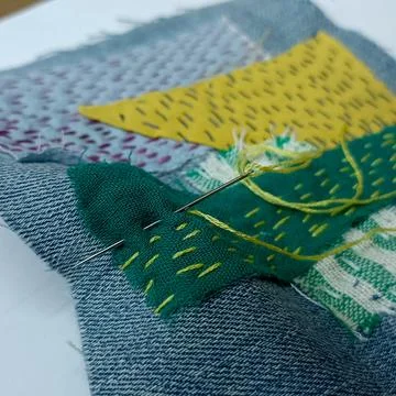 Handmade embroidered textile surface close up.  Fotos de archivo