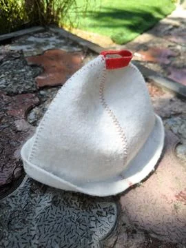 Handmade felt bath hat on stone tiles 스톡 사진