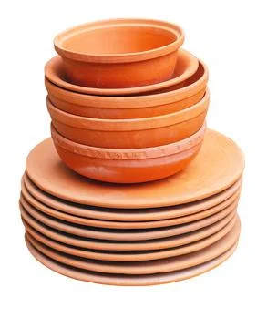 Handmade fired clay tableware on a white Stock Photos