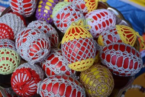 Handmade folk crochet easter eggs in baskets colorful traditional spring craft Stock Photos