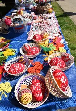 Handmade folk crochet easter eggs in baskets colorful traditional spring craft Stock Photos