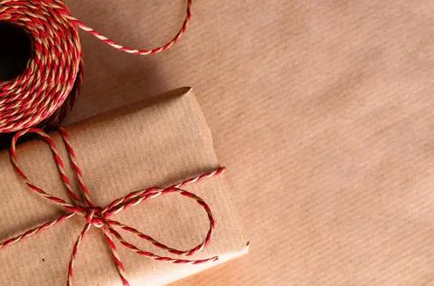 Handmade gift box Handmade gift box wrapped with craft paper and red bow C... Stock Photos