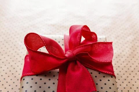 Handmade gift box wrapped with craft paper and red bow Stock Photos
