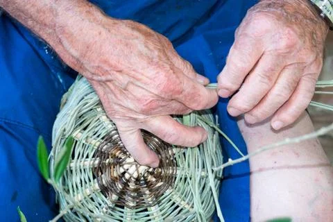 Handmade hands while making a wicker basket Stock Photos