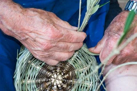 Handmade hands while making a wicker basket Stock Photos