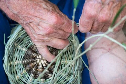 Handmade hands while making a wicker basket Stock Photos