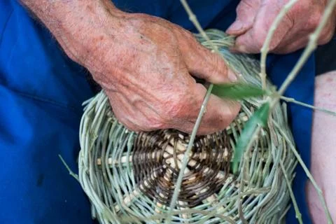 Handmade hands while making a wicker basket Stock Photos