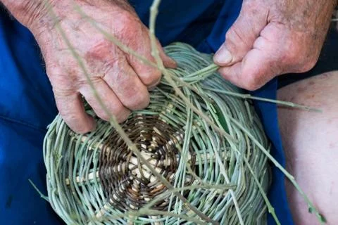 Handmade hands while making a wicker basket Stock Photos