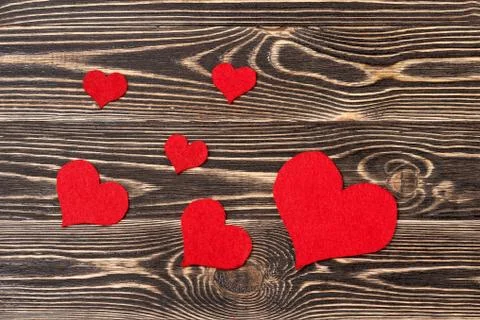 Handmade hearts against wood-grain wall Stock Photos