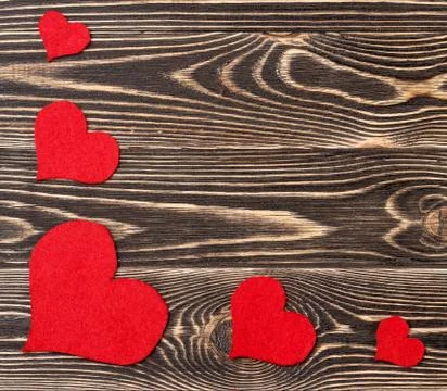 Handmade hearts against wood-grain wall Stock Photos