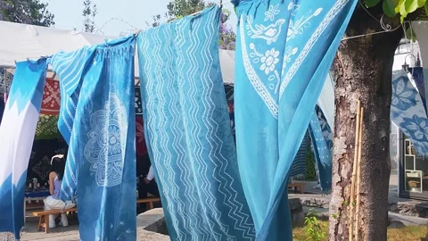 Handmade Indigo Tie Dye Fabrics Hanging to Dry in a Traditional Outdoor Workshop Stock Footage 342258891