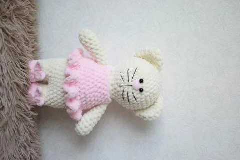 Handmade knitted toy cat on white. Hello kitty. flat lay, top view Stock Photos
