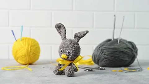 Handmade knitted toy Easter rabbit, and knitting accessories in the basket Stock Footage 149326352