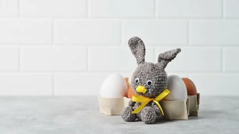 Handmade knitted toy Easter rabbit, and knitting accessories in the basket Stock Footage 149326384