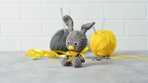 Handmade knitted toy Easter rabbit, and knitting accessories in the basket Stock Footage 149326396