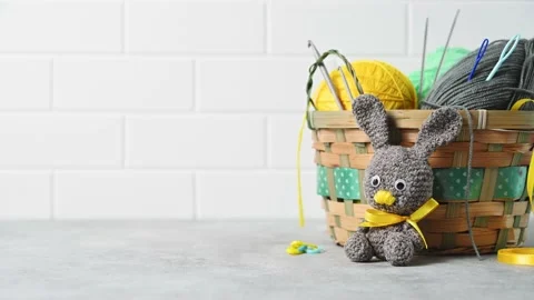 Handmade knitted toy Easter rabbit, and knitting accessories in the basket Stock Footage 149326418