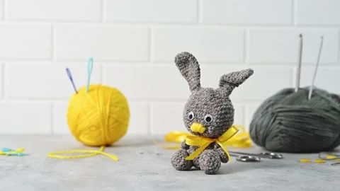 Handmade knitted toy Easter rabbit, and knitting accessories in the basket Stock Footage 149326439