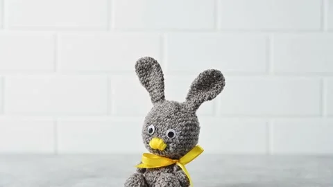 Handmade knitted toy Easter rabbit, and knitting accessories in the basket Stock Footage 149326442