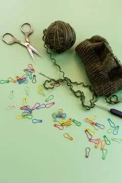 Handmade knitting workspace with yarn scissors and crochet tools Stock Photos
