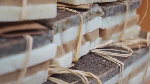 Handmade layered bar soaps stacked in neat piles tied with natural raffia s.. Stock Footage 332882252