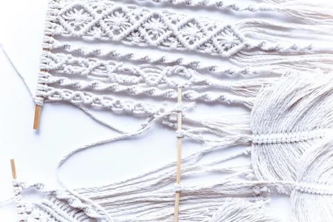 Handmade macrame braiding, background thread on a white background top view.  Stock Photos