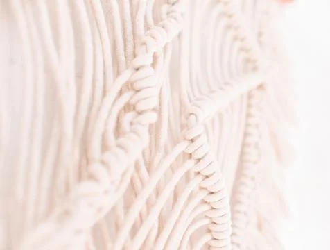 Handmade macrame pattern a fragment of a wall panel in the boho style Stock Photos