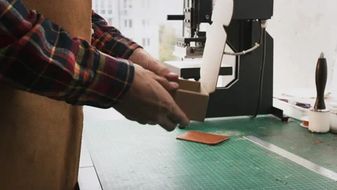 Handmade man hobbies. Young leather craftsman creates bag product for e-commerce Video stock 141604558