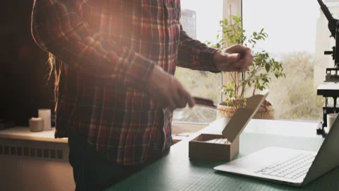 Handmade man hobbies. Young leather craftsman creates bag product for e-commerce Stock Footage 141941809