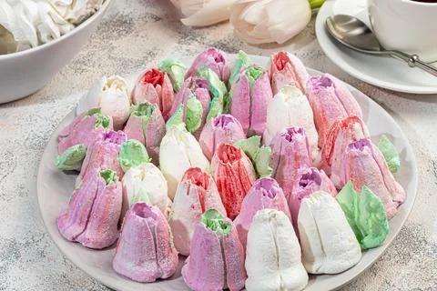 Handmade marshmallows on a light background in the form of roses, hydrangeas  Фото