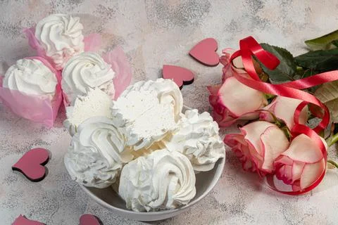 Handmade marshmallows on a light background in the form of roses, hydrangeas  Фото