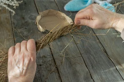 Handmade master class Easter nest made of natural dry grass and used cardboard Stock Photos