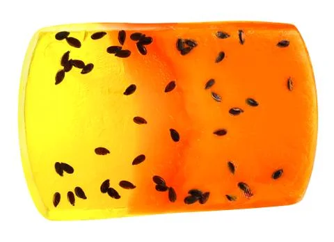 Handmade natural orange solid soap with exotic seeds, isolated on white backg Stock Photos