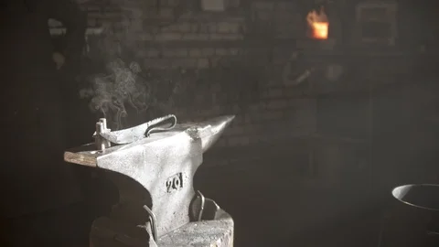 Handmade new knife with unique handle on the anvil - cool steam coming from the Stock Footage 125363769