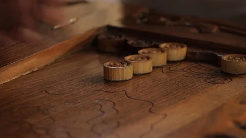 Handmade old wooden backgammon. Men play with checkers, move them to the field. Stock Footage 122298478