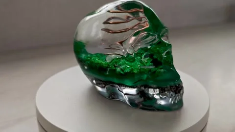 Handmade Orgone Generator Skull with Green Quartz Crystals | Clear Epoxy Resin Stock Footage 338095465