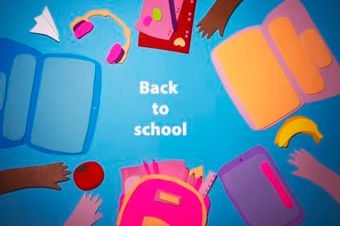 Handmade paper colored laptops, tablet and school supplies on a blue background Stock Photos